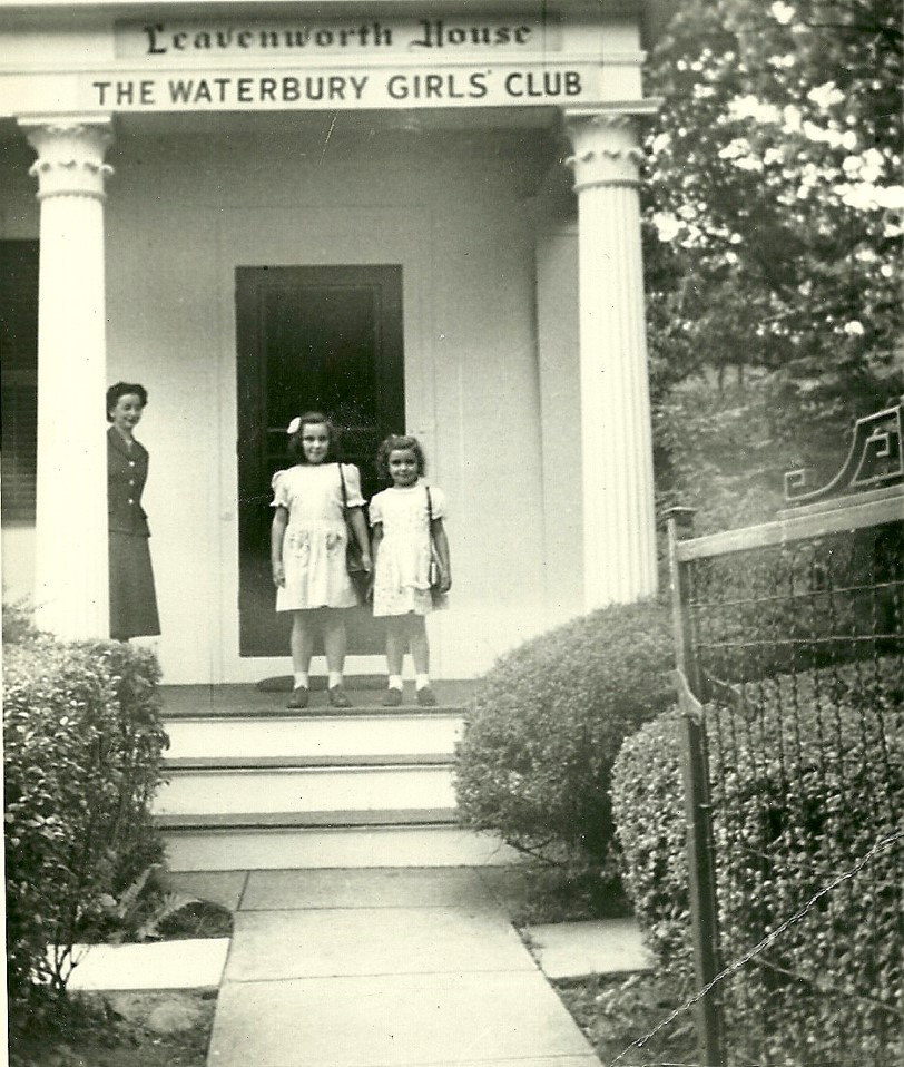 Two girls and a teacher standing on the steps of the Leavenworth house in the early 1900's.