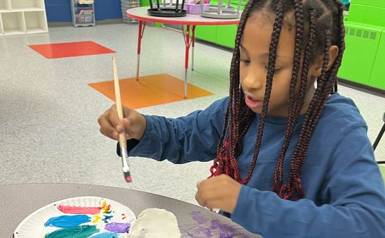 A girl engaged in a painting craft.